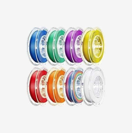Rainbow 1.75mm PLA filament spool with gradient color transitions and a multicolored 3D printed dragon figurine – suitable for creative 3D prints in Qatar